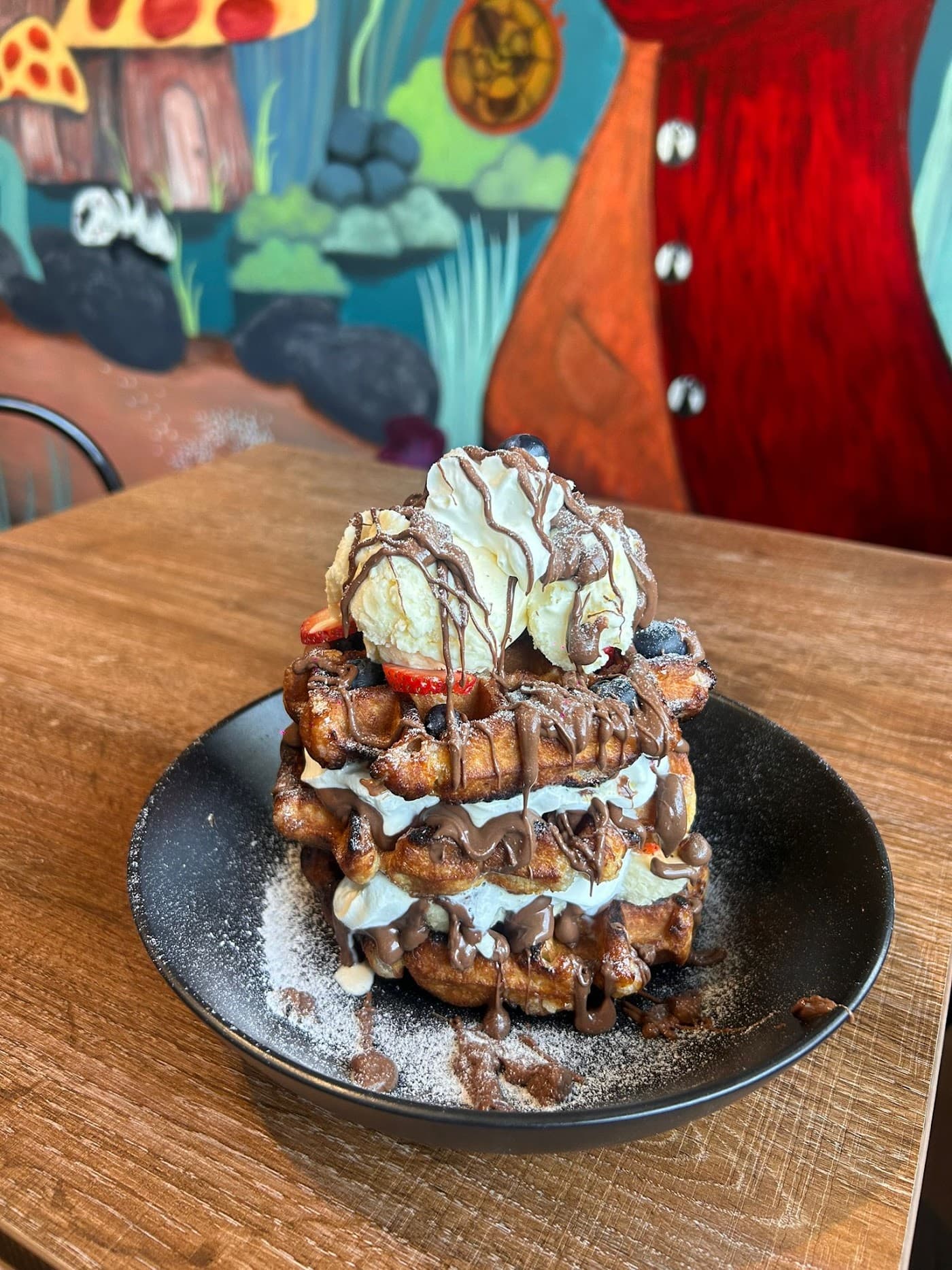 Rabbit Hole - Stacked Belgian waffles drizzled with chocolate sauce and topped with ice cream